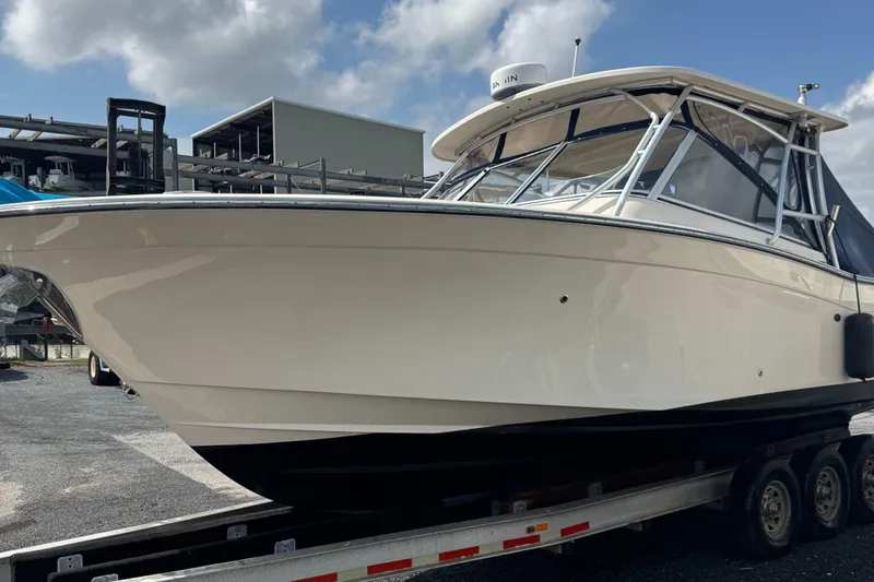  Yacht Photos Pics 2012 Grady-White Freedom 307 boat on trailer under cloudy sky.