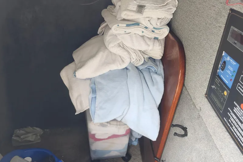  Yacht Photos Pics Interior of 2012 Grady-White Freedom 307 with stacked towels and control panel.