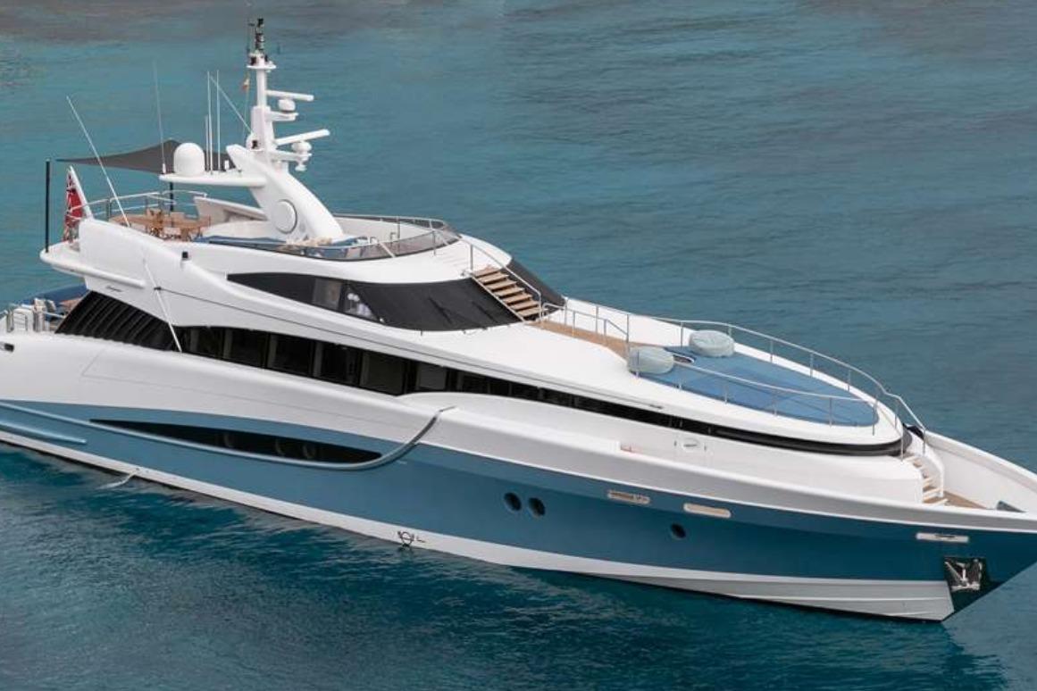 Luxurious 2005 Evolution 110 yacht cruising on clear blue waters.