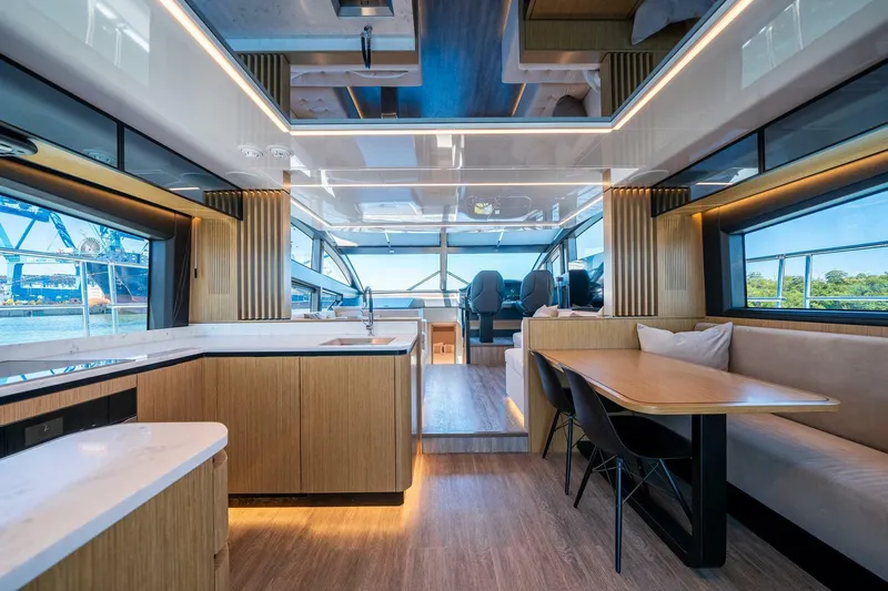  Yacht Photos Pics Luxurious interior of 2023 Pearl 62 yacht with modern kitchen and dining area.