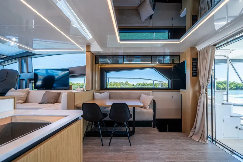  Yacht Photos Pics Luxurious interior of 2023 Pearl 62 yacht with modern seating and large windows.