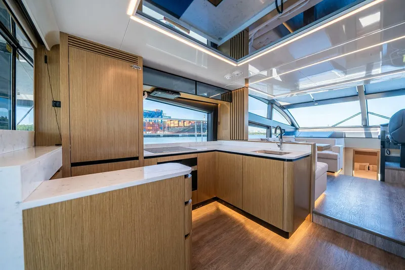  Yacht Photos Pics Luxurious interior of 2023 Pearl 62 yacht with modern kitchen and panoramic windows.
