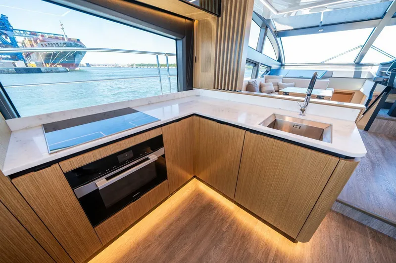  Yacht Photos Pics Modern kitchen interior on 2023 Pearl 62 yacht with sleek design and waterfront view.