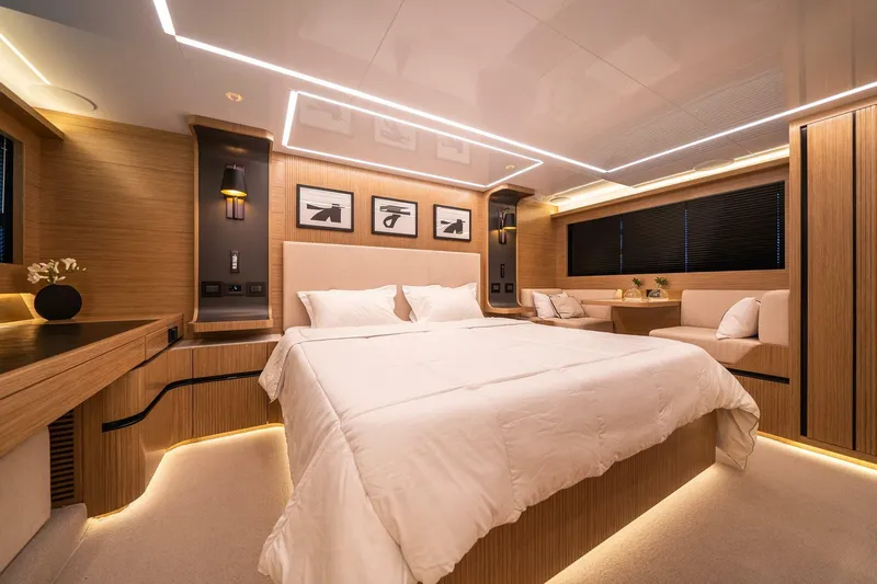  Yacht Photos Pics Luxurious bedroom interior in 2023 Pearl 62 yacht, featuring modern design and ambient lighting.