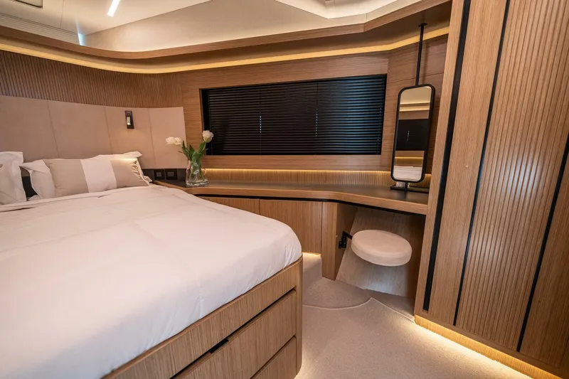  Yacht Photos Pics Luxurious 2023 Pearl 62 yacht bedroom with modern wood paneling and elegant decor.