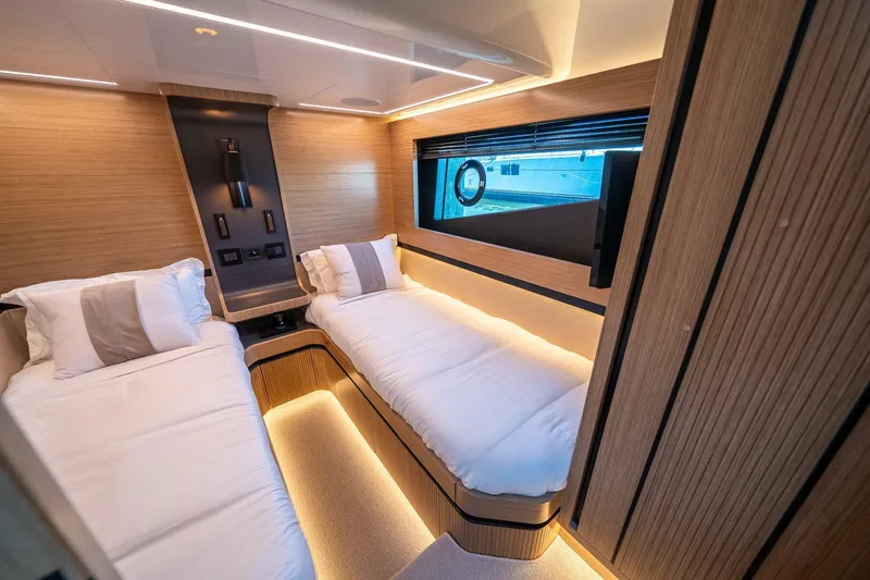  Yacht Photos Pics Luxurious cabin interior of 2023 Pearl 62 yacht with twin beds and modern design.