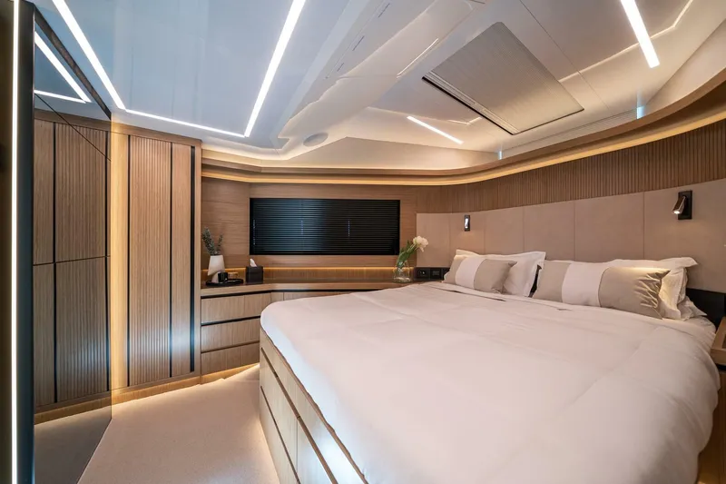  Yacht Photos Pics Luxurious bedroom interior of 2023 Pearl 62 yacht, featuring modern design and ambient lighting.