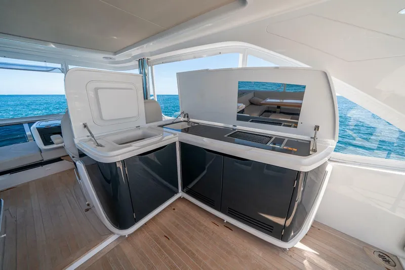  Yacht Photos Pics Luxurious 2023 Pearl 62 yacht interior with modern kitchen and ocean view.