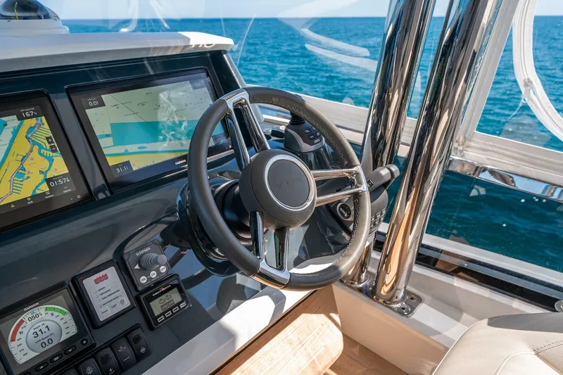  Yacht Photos Pics Steering wheel and navigation system of 2023 Pearl 62 yacht on open sea.