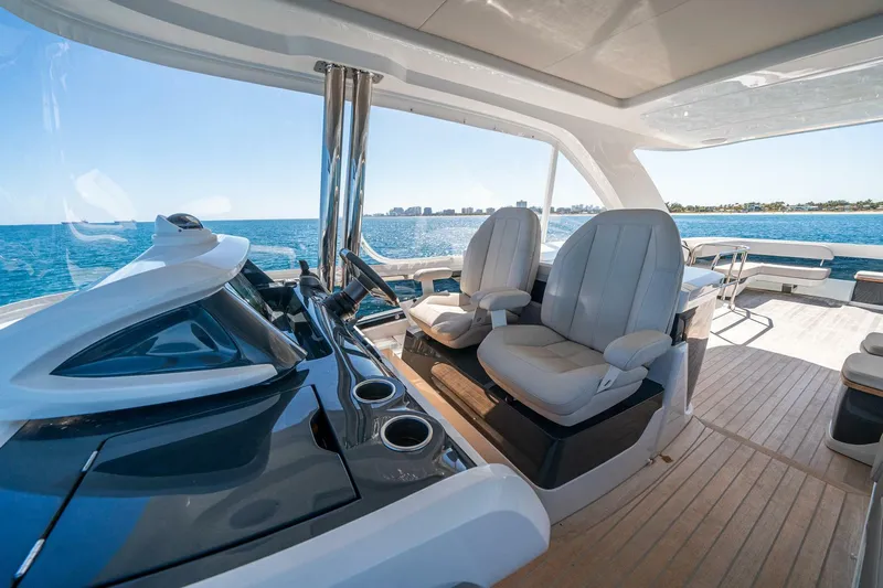  Yacht Photos Pics Luxurious 2023 Pearl 62 yacht interior with ocean view and modern seating.
