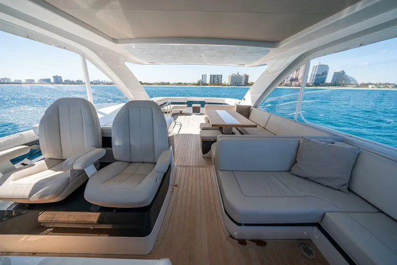  Yacht Photos Pics Luxurious 2023 Pearl 62 yacht interior with plush seating and ocean view.