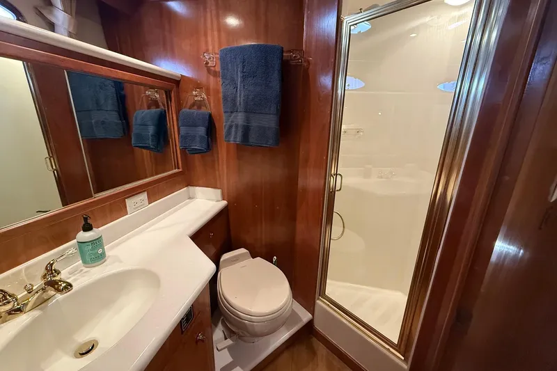  Yacht Photos Pics Luxurious bathroom in 2003 Navigator 53 yacht with shower, sink, and toilet.