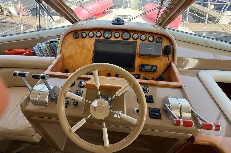  Yacht Photos Pics 2003 Navigator 53 yacht helm with steering wheel, controls, and navigation equipment.