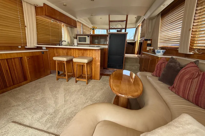  Yacht Photos Pics Luxurious interior of a 2003 Navigator 53 yacht with elegant wood finishes and cozy seating.