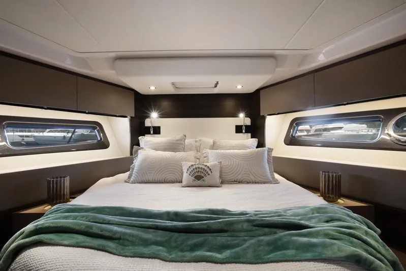  Yacht Photos Pics Luxurious bedroom interior of 2019 Azimut 50 Fly yacht with elegant bedding and ambient lighting.