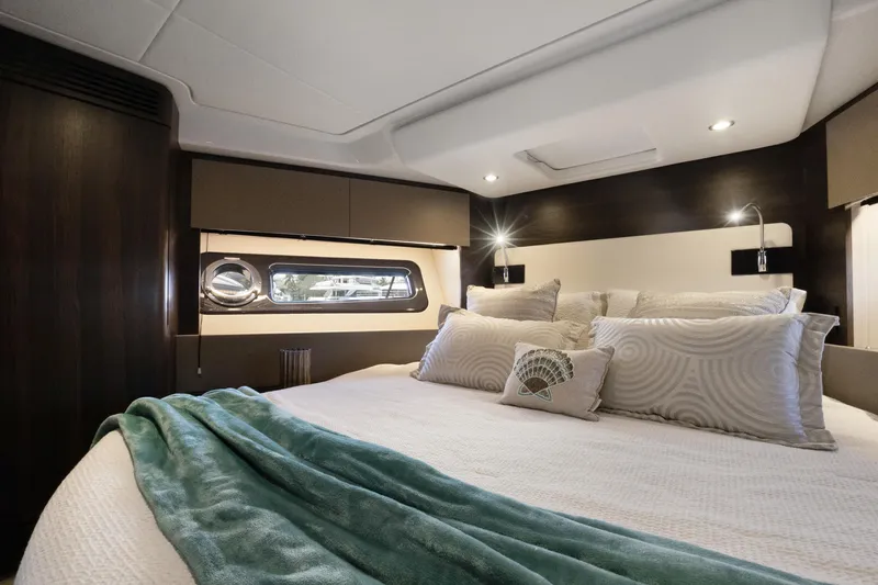  Yacht Photos Pics Luxurious bedroom interior of 2019 Azimut 50 Fly yacht with elegant bedding and modern lighting.