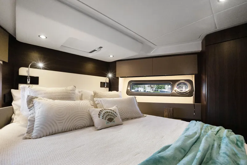  Yacht Photos Pics Luxurious bedroom interior of 2019 Azimut 50 Fly yacht with elegant bedding and modern lighting.