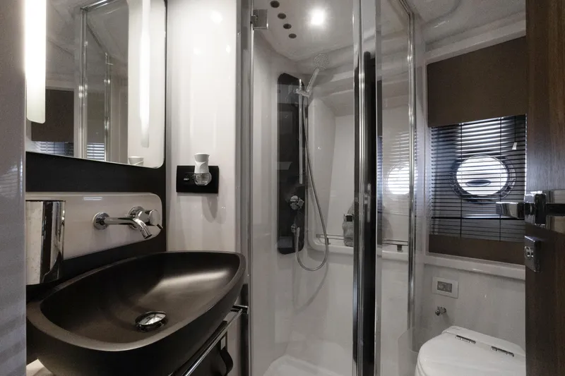  Yacht Photos Pics Luxurious bathroom interior of 2019 Azimut 50 Fly yacht with modern fixtures.