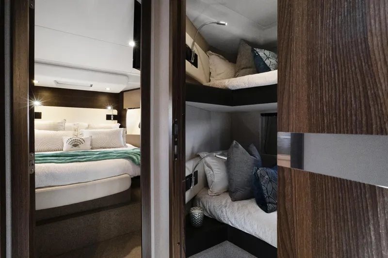  Yacht Photos Pics Luxurious interior of 2019 Azimut 50 Fly yacht with cozy bedroom and bunk beds.