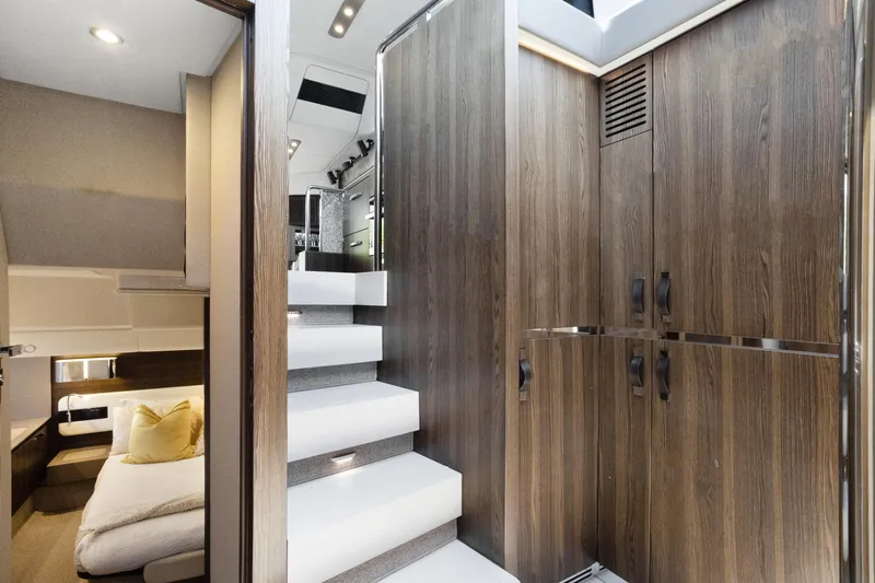  Yacht Photos Pics Interior of 2019 Azimut 50 Fly yacht with modern wood paneling and sleek staircase.