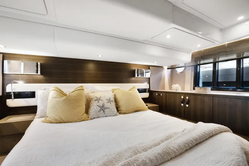  Yacht Photos Pics Luxurious bedroom interior of 2019 Azimut 50 Fly yacht with elegant decor and soft lighting.