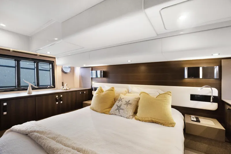  Yacht Photos Pics Luxurious bedroom interior of 2019 Azimut 50 Fly yacht with elegant decor and plush bedding.