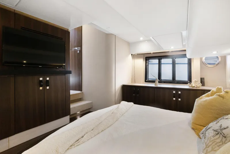  Yacht Photos Pics Luxurious bedroom interior of 2019 Azimut 50 Fly yacht with modern decor and large window.