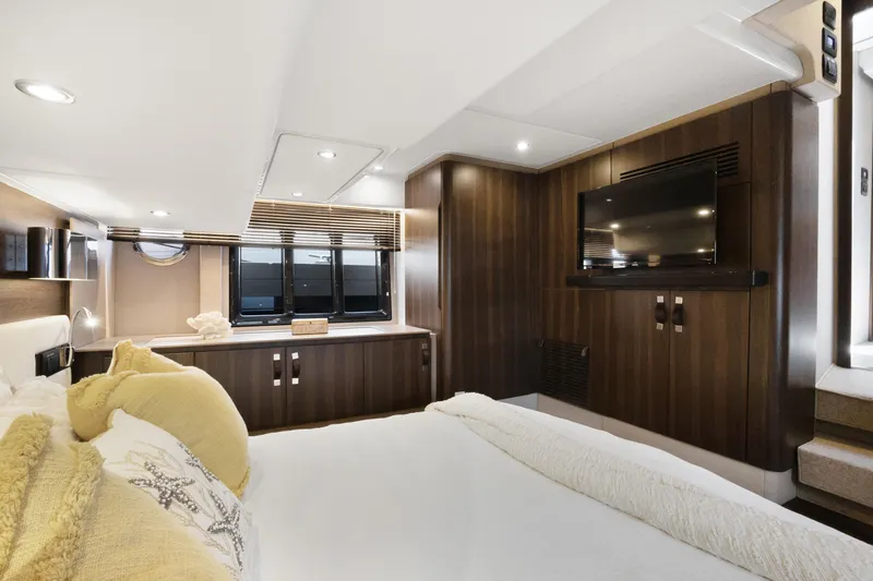  Yacht Photos Pics Luxurious interior of 2019 Azimut 50 Fly yacht with modern wood finishes and cozy bedding.