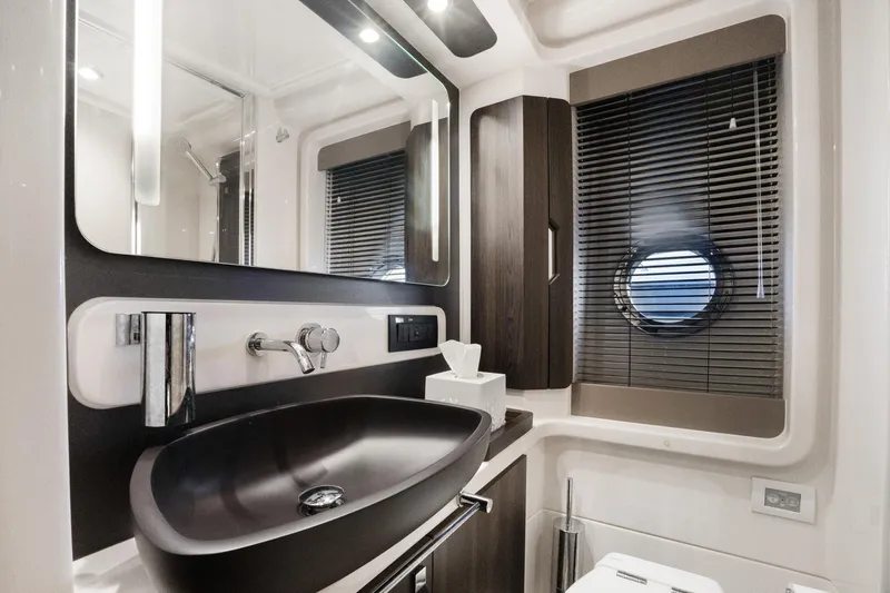  Yacht Photos Pics Luxurious bathroom interior of 2019 Azimut 50 Fly yacht with modern fixtures.
