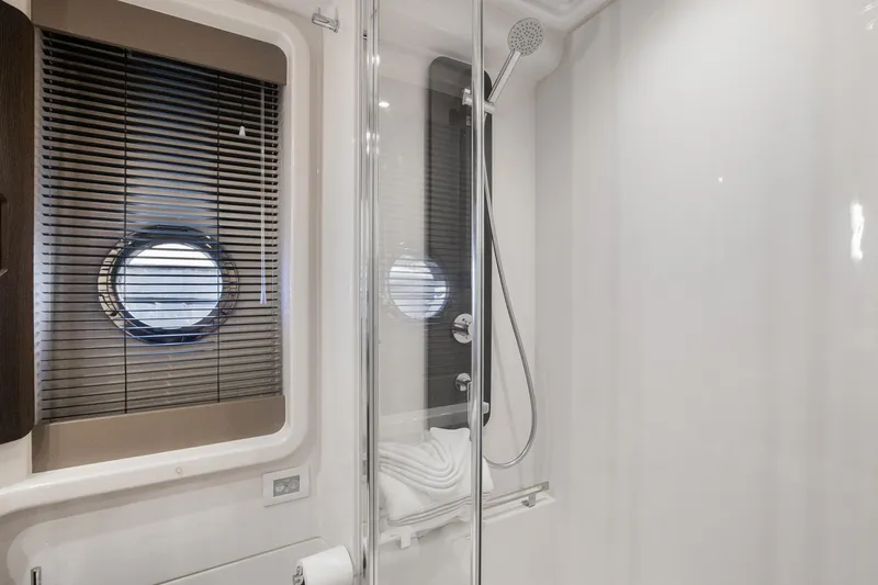 Yacht Photos Pics Luxurious bathroom in 2019 Azimut 50 Fly yacht with modern shower and porthole window.