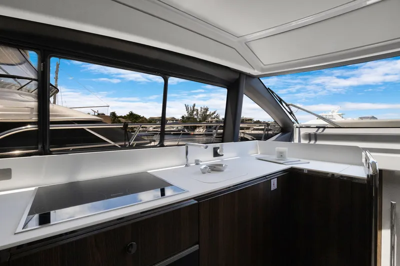  Yacht Photos Pics Interior view of 2019 Azimut 50 Fly yacht kitchen with modern design and large windows.