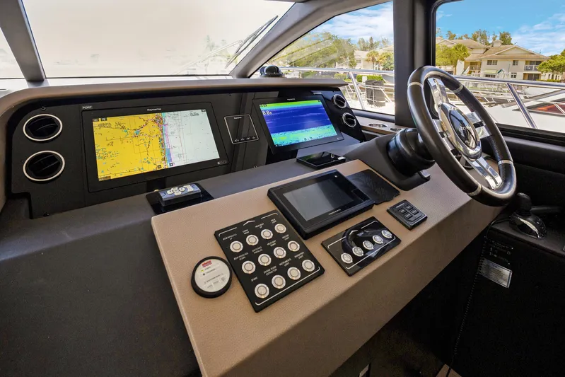  Yacht Photos Pics Cockpit of 2019 Azimut 50 Fly yacht with navigation screens and steering wheel.