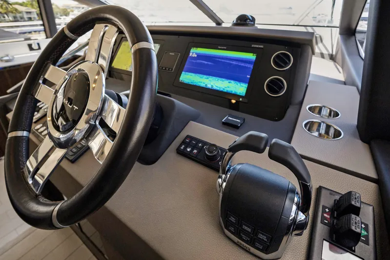  Yacht Photos Pics Cockpit of 2019 Azimut 50 Fly yacht with steering wheel and navigation display.