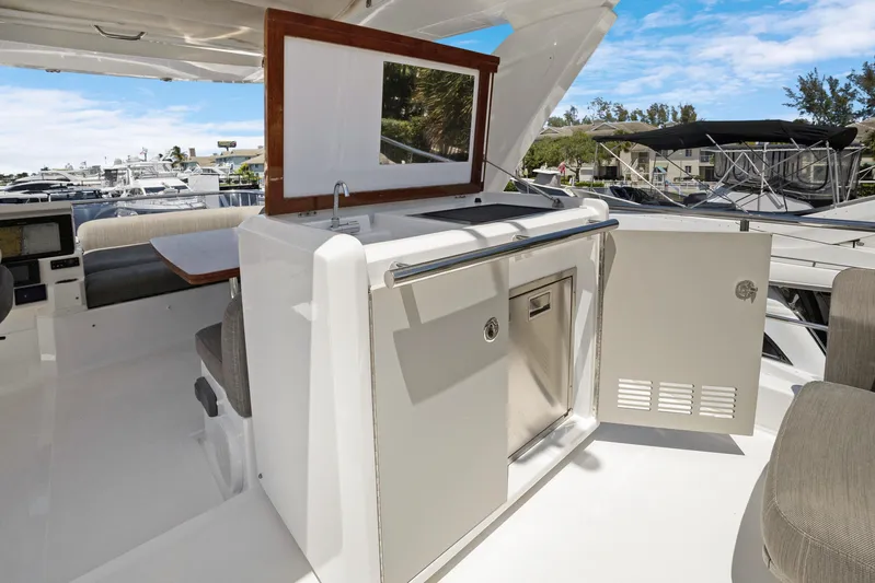 Yacht Photos Pics 2019 Azimut 50 Fly yacht interior with kitchenette and seating area.