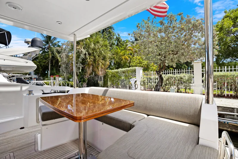  Yacht Photos Pics Luxurious 2019 Azimut 50 Fly yacht deck with elegant seating and wooden table.