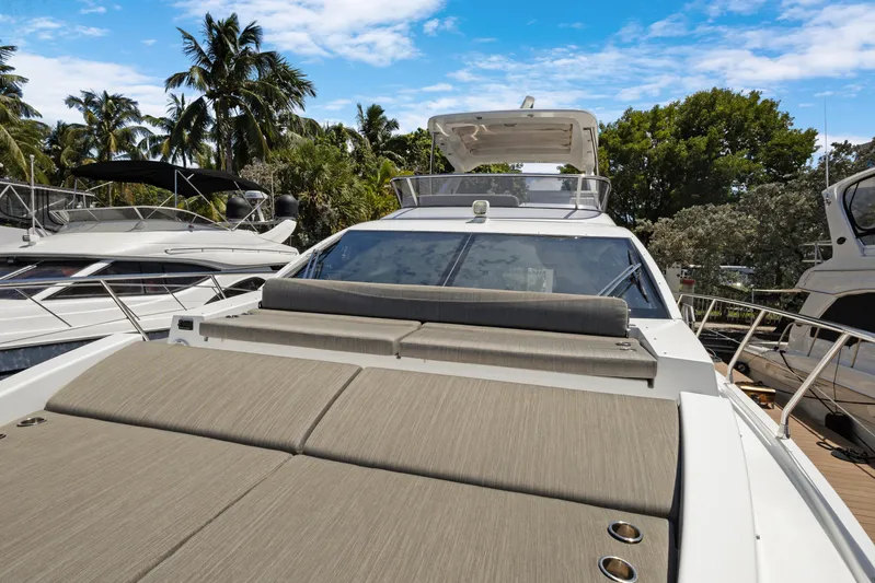  Yacht Photos Pics 2019 Azimut 50 Fly yacht with sunbathing area, docked among palm trees.