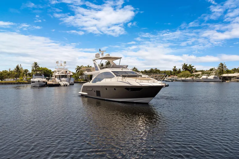  Yacht Photos Pics Luxurious 2019 Azimut 50 Fly yacht on serene water under blue sky.