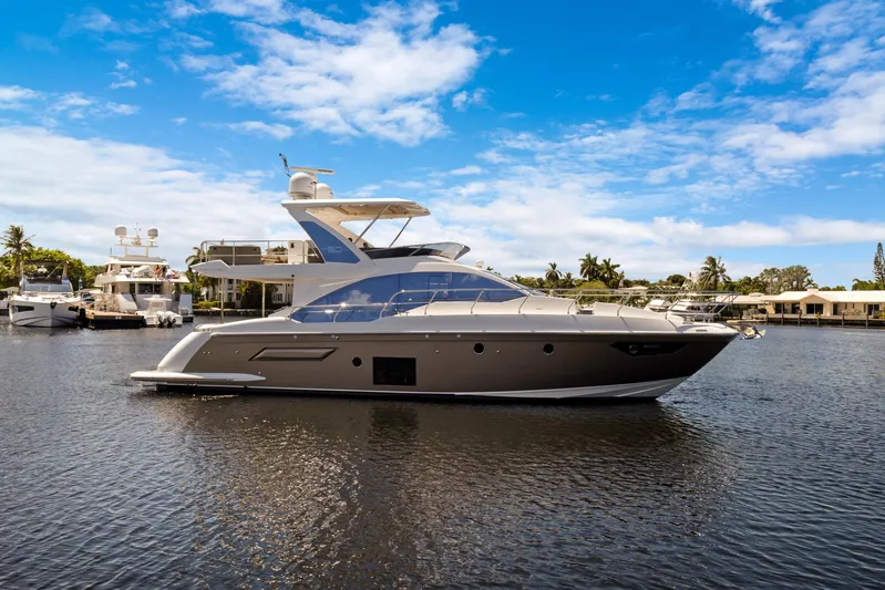  Yacht Photos Pics 2019 Azimut 50 Fly yacht on calm water under a clear blue sky.