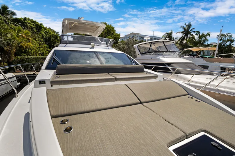  Yacht Photos Pics 2019 Azimut 50 Fly yacht with sun deck, docked alongside other boats.