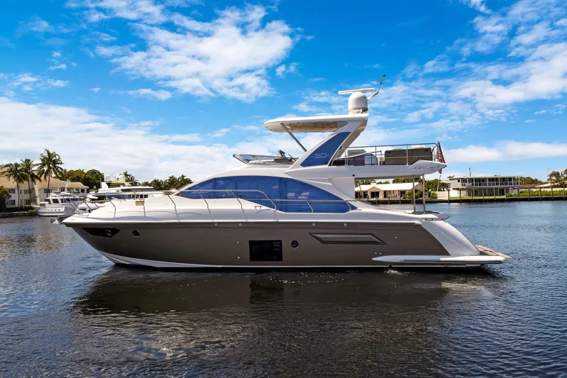  Yacht Photos Pics 2019 Azimut 50 Fly yacht on calm water under a clear blue sky.