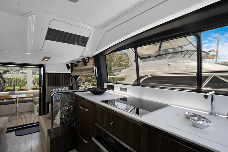  Yacht Photos Pics Luxurious interior of 2019 Azimut 50 Fly yacht with modern kitchen and large windows.