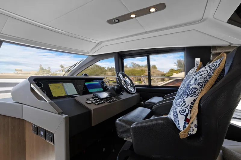  Yacht Photos Pics Interior of 2019 Azimut 50 Fly yacht cockpit with modern controls and plush seating.