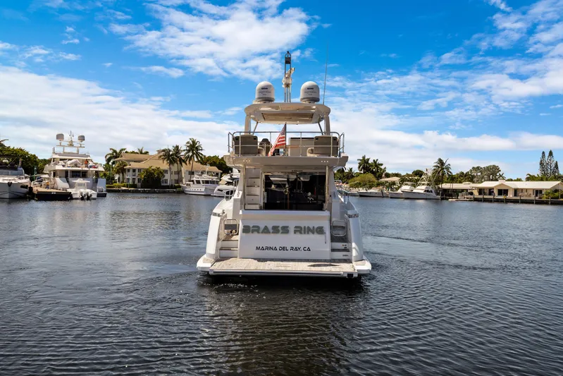  Yacht Photos Pics 2019 Azimut 50 Fly yacht on a serene marina with palm trees and blue sky.