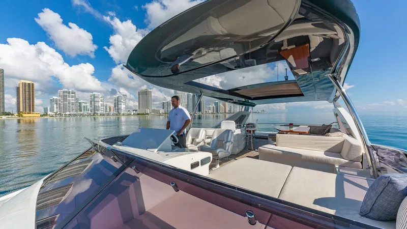 Golden 3 Yacht Photos Pics Luxurious 2015 Dominator 800 yacht cruising near city skyline on a sunny day.