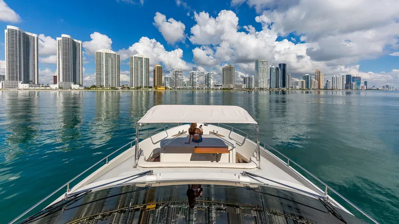 Golden 3 Yacht Photos Pics Luxury yacht Dominator 800 cruising near city skyline, 2015 model.