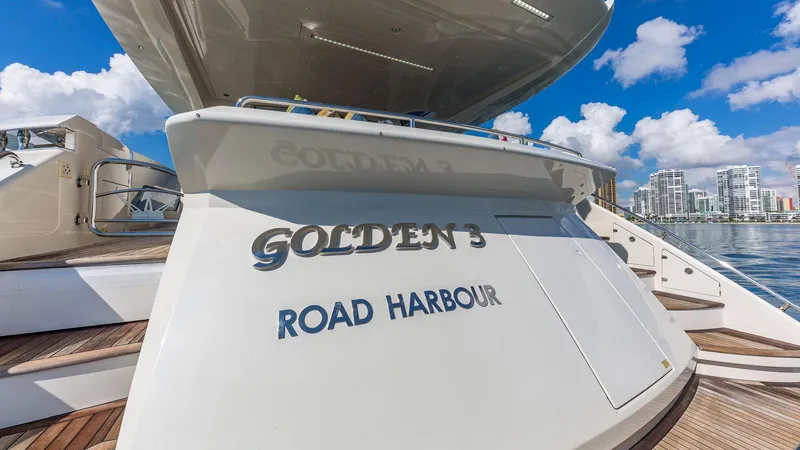 Golden 3 Yacht Photos Pics Luxury yacht "Golden 3" at Road Harbour, Dominator 800, 2015 model, docked under blue sky.