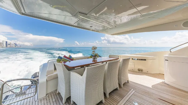 Golden 3 Yacht Photos Pics Luxurious 2015 Dominator 800 yacht deck with dining area, ocean view, and elegant seating.