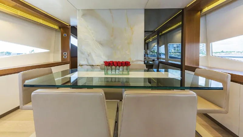 Golden 3 Yacht Photos Pics Luxurious dining area on 2015 Dominator 800 yacht with glass table and elegant decor.