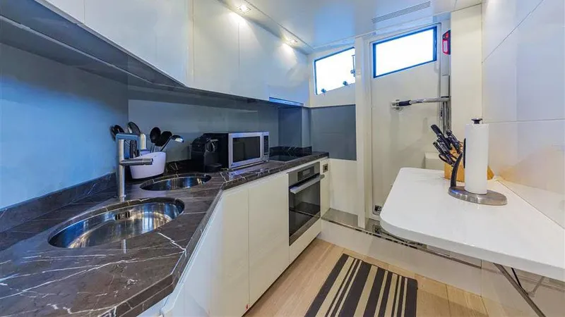 Golden 3 Yacht Photos Pics Modern yacht kitchen with marble countertops, stainless steel appliances, and ample storage. Dominator 800, 2015.