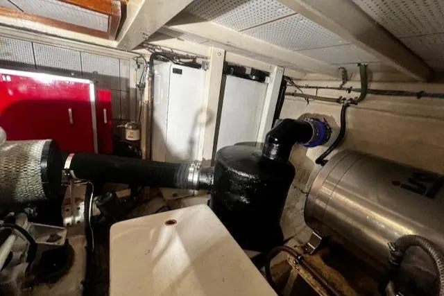 North Star Yacht Photos Pics Engine room of a 1984 Grand Banks Trawler, featuring pipes and mechanical components.